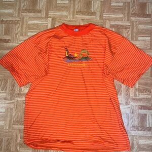 Orange and white striped t-shirt with sailboat embroidery